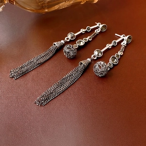 Elegant long tassel earrings with silver finish and dark green crystal in boho vintage style
