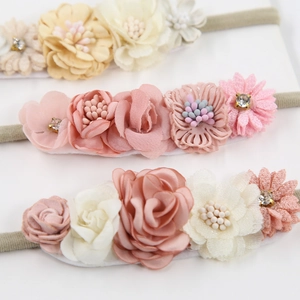 Three-pack handmade elastic baby flower headbands in beige and pink with rhinestones