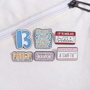 Enamel pins set inspired by Taylor Swift featuring The Eras Tour and Swiftie text designs