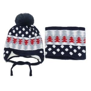 Detailed knit texture of navy blue kids beanie and scarf set with tree and dot pattern