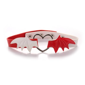 Detail of red and white bat wing choker with a heart metal ring and leather texture