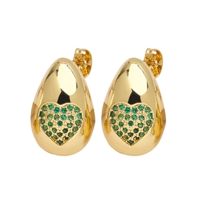 Macro shot of gold-plated drop earrings featuring green heart stones and zircon inlay