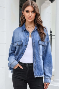 Detail of vintage washed blue denim shirt with drop shoulder design and front pockets