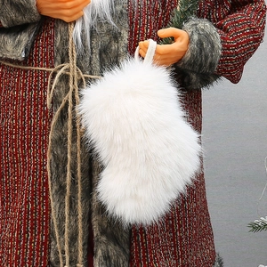 White faux fur Christmas stocking held by Santa, decorative holiday hanging gift bag