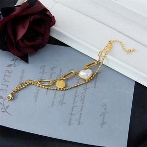 Double-layered gold chain bracelet with heart pendant and engraved Love Dream charm