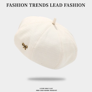 Solid beige knitted beret hat for women with a vintage golden bow metal badge
