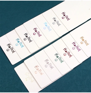 Close-up of white kraft paper jewelry display cards with colorful Hello text