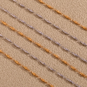 Macro detail of gold and silver bean link jewelry chains with fine metallic texture