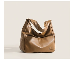 Detailed view of caramel brown soft PU leather tote bag with smooth texture and fine stitching