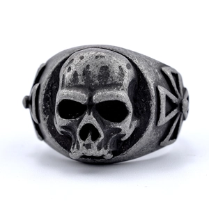 Detailed view of vintage silver skull ring with cross engravings in punk gothic style
