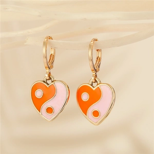 Golden heart-shaped Yin Yang drop earrings with orange and pink enamel finish