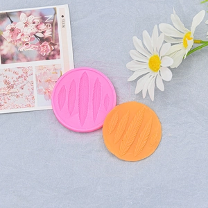 Pink and orange silicone feather molds for DIY cake decorating and fondant crafting