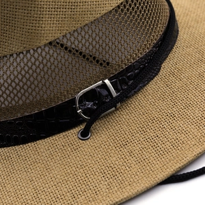 Close-up of a woven straw sun hat with breathable mesh and crocodile leather band