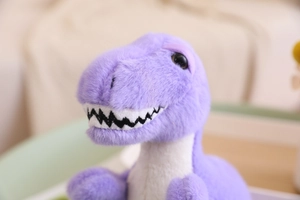Close-up of purple plush dinosaur toy showing detailed white teeth and soft fabric texture