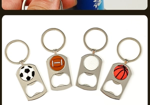 Close-up of metal sports-themed keychain bottle openers with ball patterns