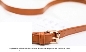 Detail of brown leather strap with adjustable gold metal buckle for shoulder bag length