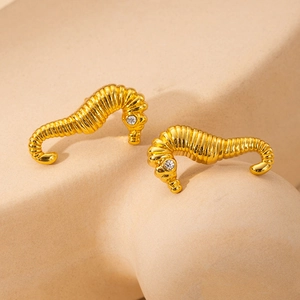 Detail of gold-plated stainless steel seahorse earrings with shimmering zircon eyes