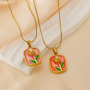 Detailed macro view of tulip flower pendants with enamel glaze and pearl accents