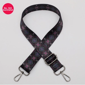 Macro detail of bohemian geometric woven purse strap No. 583 with gunmetal swivel hooks
