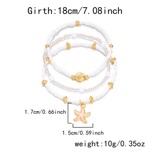 Detail view of four-layer bohemian bracelets with gold starfish and shell charms