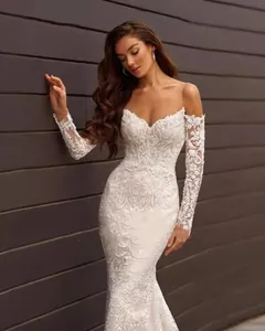 Detail of elegant sweetheart neckline and long lace sleeves on white mermaid wedding dress