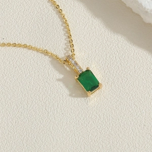 Detail of a 14K gold plated necklace with a rectangular emerald green zircon pendant