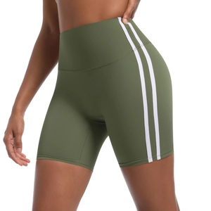 Detail view of olive green high-waisted yoga shorts with white side stripes and slim fit