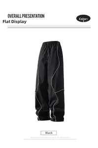 Detail view of black casual pants showing elastic waistband with drawstring and white piping