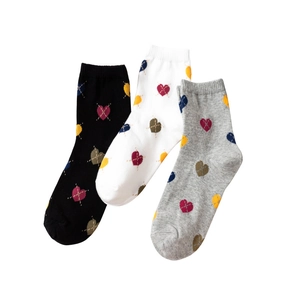 Three pairs of cotton crew socks with colorful diamond heart patterns in black, white, and grey