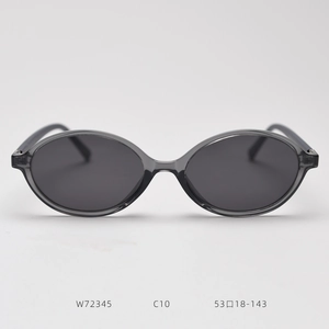 Close-up of small oval sunglasses with dark gray translucent frames and lens specs