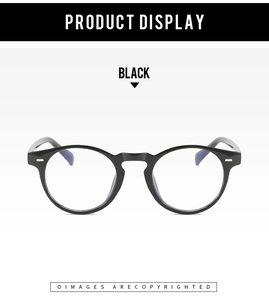 Detailed view of black round frame glasses with retro metal studs and elegant finish