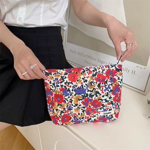 Floral cotton makeup bag with red blue yellow patterns and branded woven label