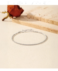 Macro detail of fine S925 sterling silver faceted bead bracelet with lobster clasp