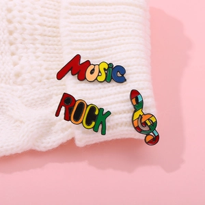 Colorful enamel music theme brooch set with ROCK and MUSIC letters on white fabric