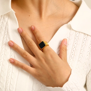 Minimalist 18k gold plated titanium ring with square black enamel stone on model hand