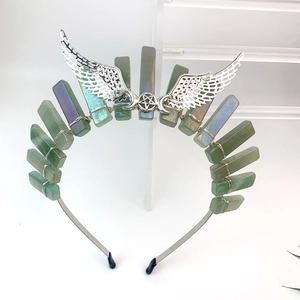 Detail view of green crystal headband with silver wings and star wire wrapping