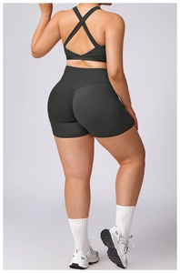 Detail of cross-back yoga bra and high-waist shorts in black moisture-wicking fabric