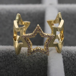 Macro shot of 18K gold plated ring featuring cutout stars set with pink cubic zirconia