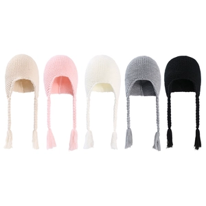 Detail of five colored knit baby hats with braided earflaps and soft fleece lining