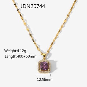 Close-up of a 18k gold chain necklace featuring a purple square zirconia pendant