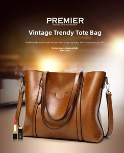 Detail of vintage brown leather tote bag with large capacity and removable shoulder strap
