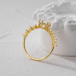 Detailed side view of golden S925 sterling silver ring with pavé set diamond band