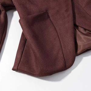 Close-up of burgundy faux suede jacket showing pocket detail and durable double stitching