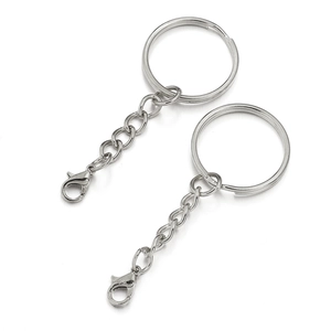 Detail view of two silver metal keychains with chain links and lobster clasp fasteners