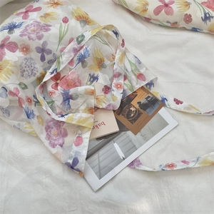 Close-up of lightweight floral mesh tote bag with colorful tulip print and sheer texture