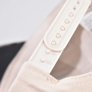Detail of adjustable plastic strap and high-density cotton texture on leopard baseball cap