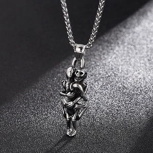 Detailed view of vintage dual skeleton hug pendant in retro silver stainless steel finish