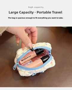 Close-up of floral quilted mini makeup pouch showing capacity with lip glosses inside