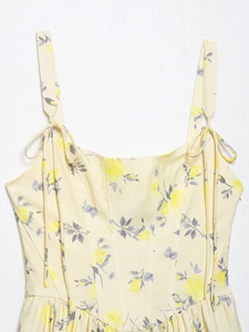 Close-up of pale yellow floral poplin dress with adjustable bow shoulder straps
