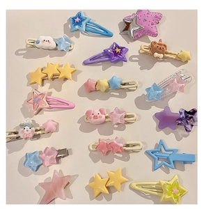 Close-up of colorful macaron resin hair clips featuring stars, clouds, and animal shapes
